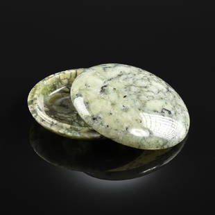 A CHINESE NEPHRITE JADE LIDDED BOX,: A CHINESE NEPHRITE JADE LIDDED BOX, in the late Qing Dynasty taste, of circular form, the top a translucent, pale green, over a surmount with a fatty interior texture with icy transparent to