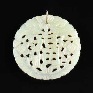 A PALE GREEN JADE RETICULATED BLESSING PENDANT,: A PALE GREEN JADE RETICULATED BLESSING PENDANT, CHINESE, centering a calligraphic character, surmounted by a descending bat form and flanked by flower blooms. Diameter: 2"