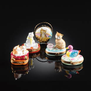 A GROUP OF FIVE LIMOGES POLYCHROME ENAMELED PORCELAIN: A GROUP OF FIVE LIMOGES POLYCHROME ENAMELED PORCELAIN KITTEN OR DUCK THEMED PILL BOXES, EACH SIGNED, MODERN, comprising one modeled as a tabby mother and her kitten snuggling on a double pillow bed, o