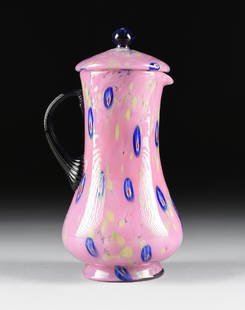 AN ITALIAN CASED ART GLASS PITCHER WITH LID, PROBABLY: AN ITALIAN CASED ART GLASS PITCHER WITH LID, PROBABLY MURANO, CIRCA 1960-1970, of baluster form with applied ribbed dark blue "C" shape handle, in mottled pink glass with chartruese and blue murine