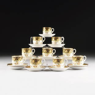 A SET OF TEN VICTORIAN PARCEL GILT AND POLYCHROME: A SET OF TEN VICTORIAN PARCEL GILT AND POLYCHROME PAINTED GREEN GROUND PORCELAIN CUPS AND SAUCERS, POSSIBLY FRENCH, OVERGLAZE GILT AND IMPRESSED NUMBERS, LATE 19TH/EARLY 20TH CENTURY, each cup with a