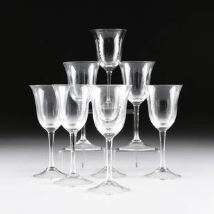 A SET OF EIGHT CRYSTAL WHITE WINE STEMWARE,: A SET OF EIGHT CRYSTAL WHITE WINE STEMWARE, each with flared rim cut detailed bowl on a tapering circular stem ending on a conforming base. Modern. Height: 7 3/4"