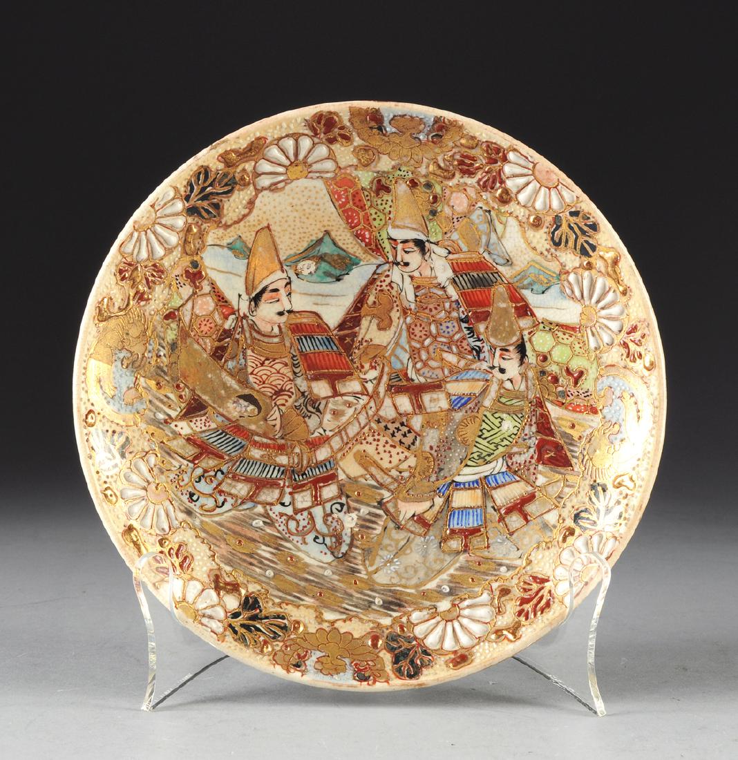 A MEIJI PERIOD SATSUMA PLATE,: A MEIJI PERIOD SATSUMA PLATE, enameled in shades of cinnabar, teal and black and enhanced with gilding. Diameter: 7 1/2"