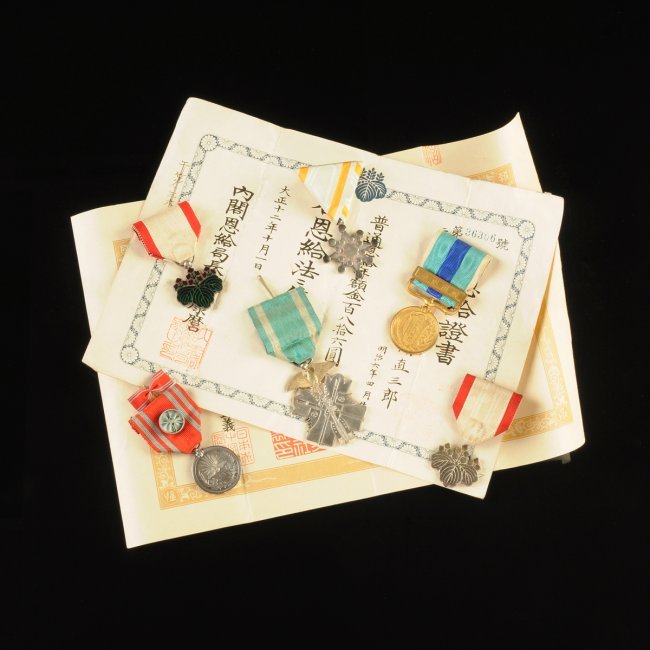 A GROUP OF IMPERIAL JAPANESE MEDALS AND DOCUMENTS IN (1 of 10)