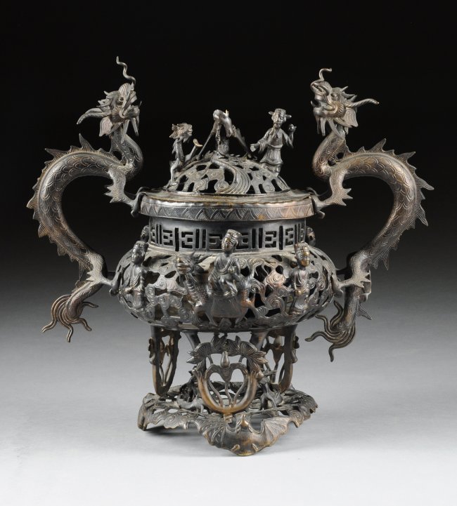 A VINTAGE CHINESE PATINATED BRONZE CENSER, REPUBLIC: A VINTAGE CHINESE PATINATED BRONZE CENSER, REPUBLIC PERIOD (1912-1949), elaborately cast with a reticulated squat bulbous body of stylized scrolling clouds centering sides modeled with Immortal figure