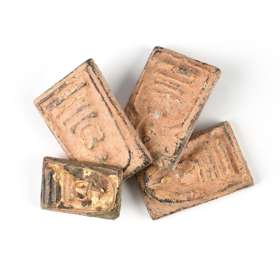 A GROUP OF FOUR BUDDHIST PARCEL GILT TERRACOTTA TSA TSA (1 of 11)