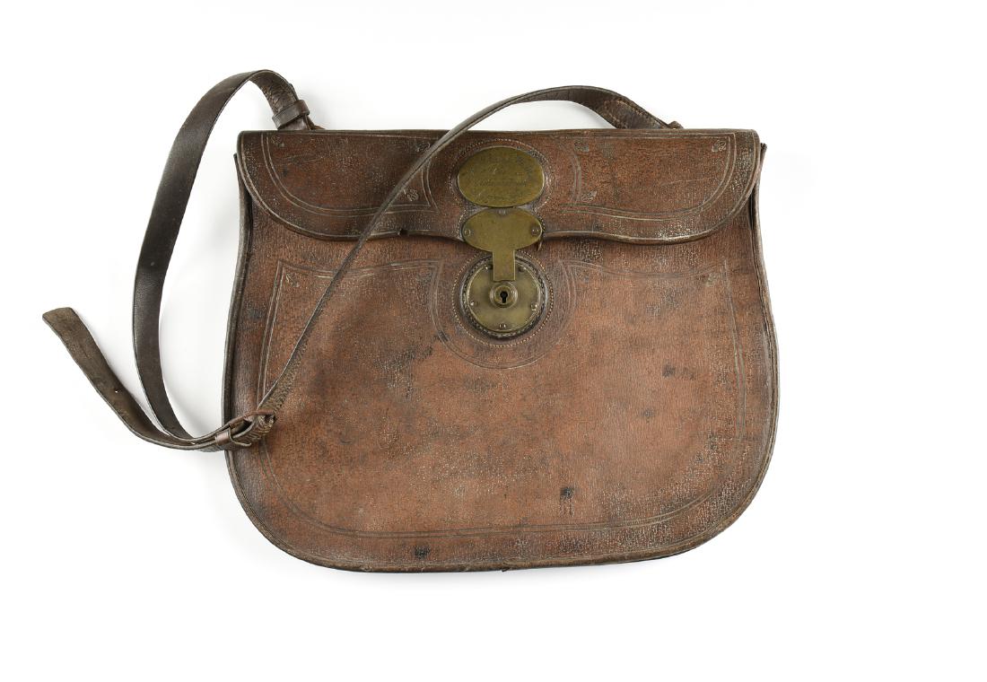 AN ANTIQUE LEATHER AND BRONZE GENTLEMAN'S TRAVEL: AN ANTIQUE LEATHER AND BRONZE GENTLEMAN'S TRAVEL SATCHEL, IRISH, 1850-1870, embossed leather, the flap with plaque inscribed, "For St. Vincent Whithed, Bart., Killingcarrick, Greystone," likely belong