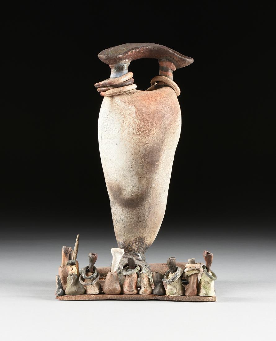 DENNIS W. SMITH (American 20th Century) A RAKU CERAMIC: DENNIS W. SMITH (American 20th Century) A RAKU CERAMIC SCULPTURE, "Sentinel Game," SAN ANTONIO, TEXAS, CIRCA 1995, of thrown and altered baluster form with curved handle raised on posts with rings, ra