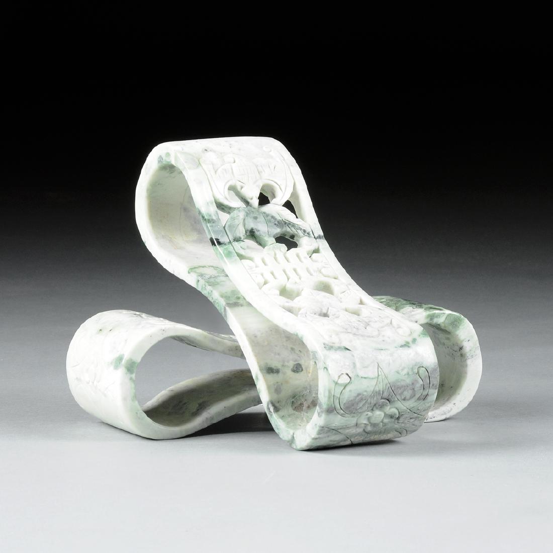 A PAIR OF CHINESE CARVED GREEN AND WHITE MOTTLED JADE: A PAIR OF CHINESE CARVED GREEN AND WHITE MOTTLED JADE PILLOWS, 20TH CENTURY, each of flat ribbon form with compressed centers enclosing reticulated bats and peaches flanking a shou symbol, reversing t