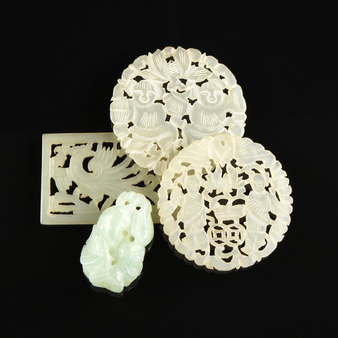 A GROUP OF FOUR WHITE TO PALE GREEN JADE PENDANTS, (1 of 6)