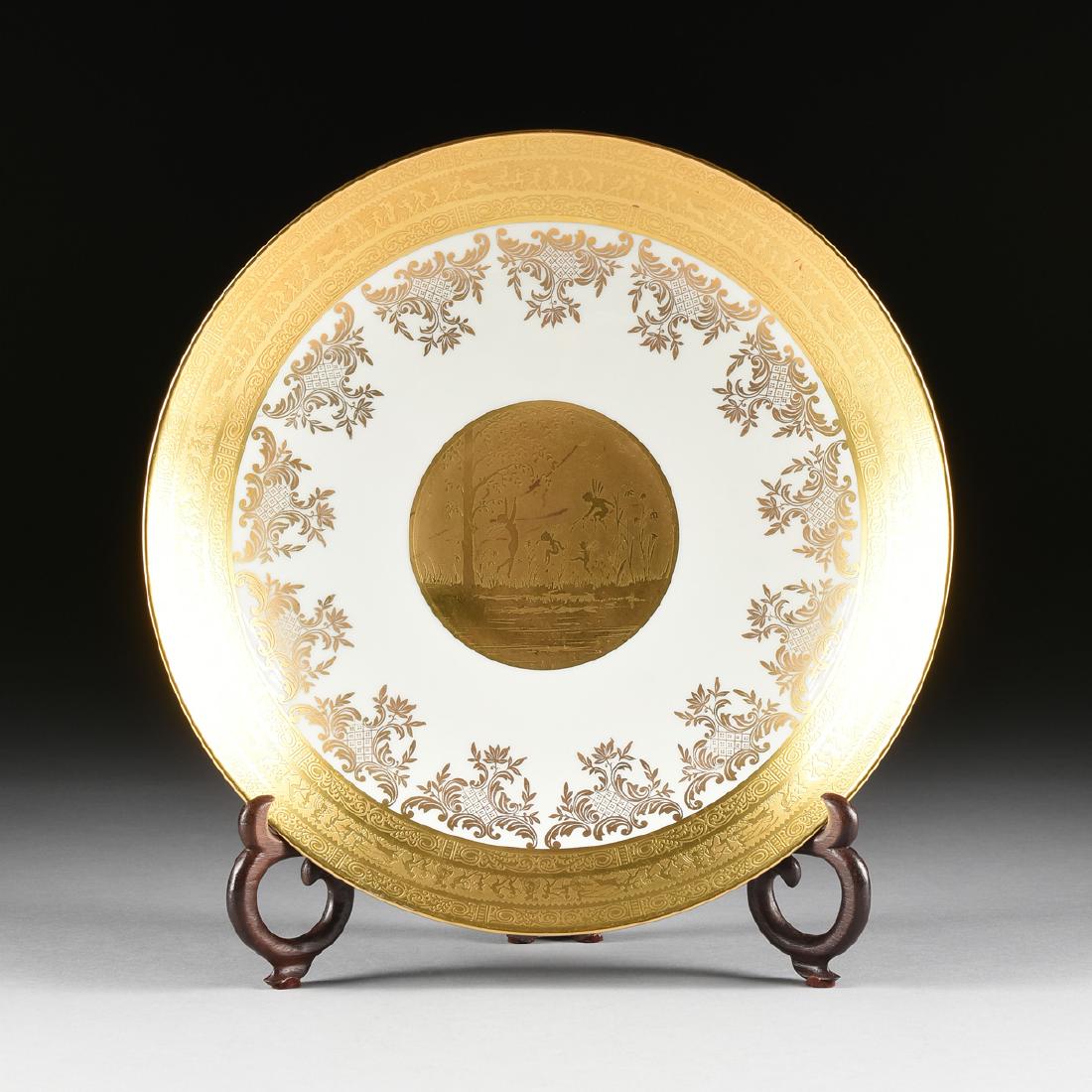 A GERMAN PORCELAIN CHARGER WITH GILT FAIRY AND PIXIE: A GERMAN PORCELAIN CHARGER WITH GILT FAIRY AND PIXIE DECORATION, FOR FERDINAND BING & CO., NEW YORK, NEW YORK, CIRCA 1925-1931, the deep charger with triple band of gilt decoration to the rim, the cen