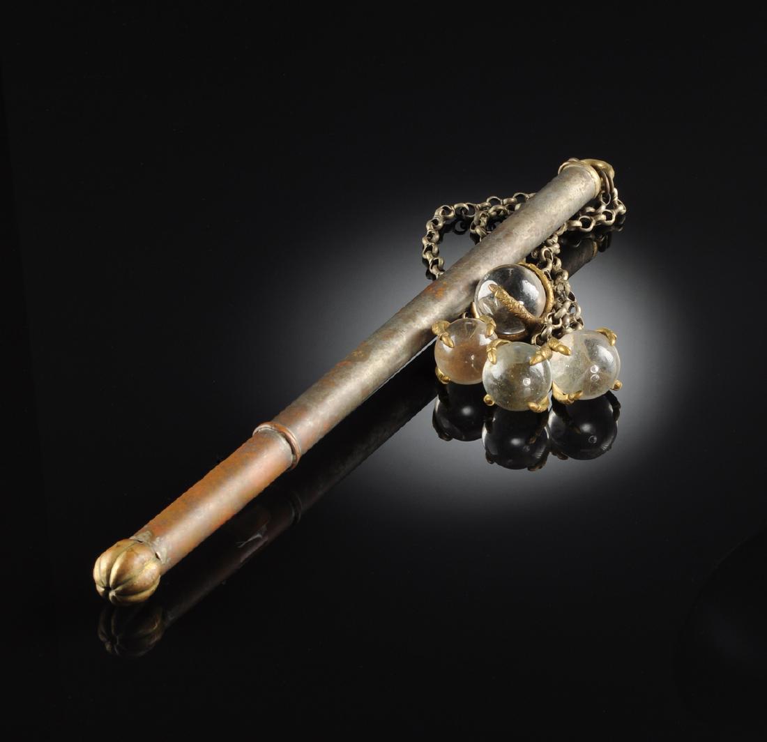 A VINTAGE SILVERED METAL AND CHAINED GLASS BALL FLAIL,: A VINTAGE SILVERED METAL AND CHAINED GLASS BALL FLAIL, 20TH CENTURY, the cylindrical rod form handle ending in a brass melon form lobed sphere opposite a brass loop cap suspending four chains ending i