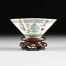 A CHINESE EXPORT FAMILLE ROSE RICEWARE PORCELAIN CUP ON