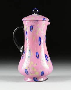 AN ITALIAN CASED ART GLASS PITCHER WITH LID, PROBABLY: AN ITALIAN CASED ART GLASS PITCHER WITH LID, PROBABLY MURANO, CIRCA 1960-1970, of baluster form with applied ribbed dark blue "C" shape handle, in mottled pink glass with chartruese and blue murine in