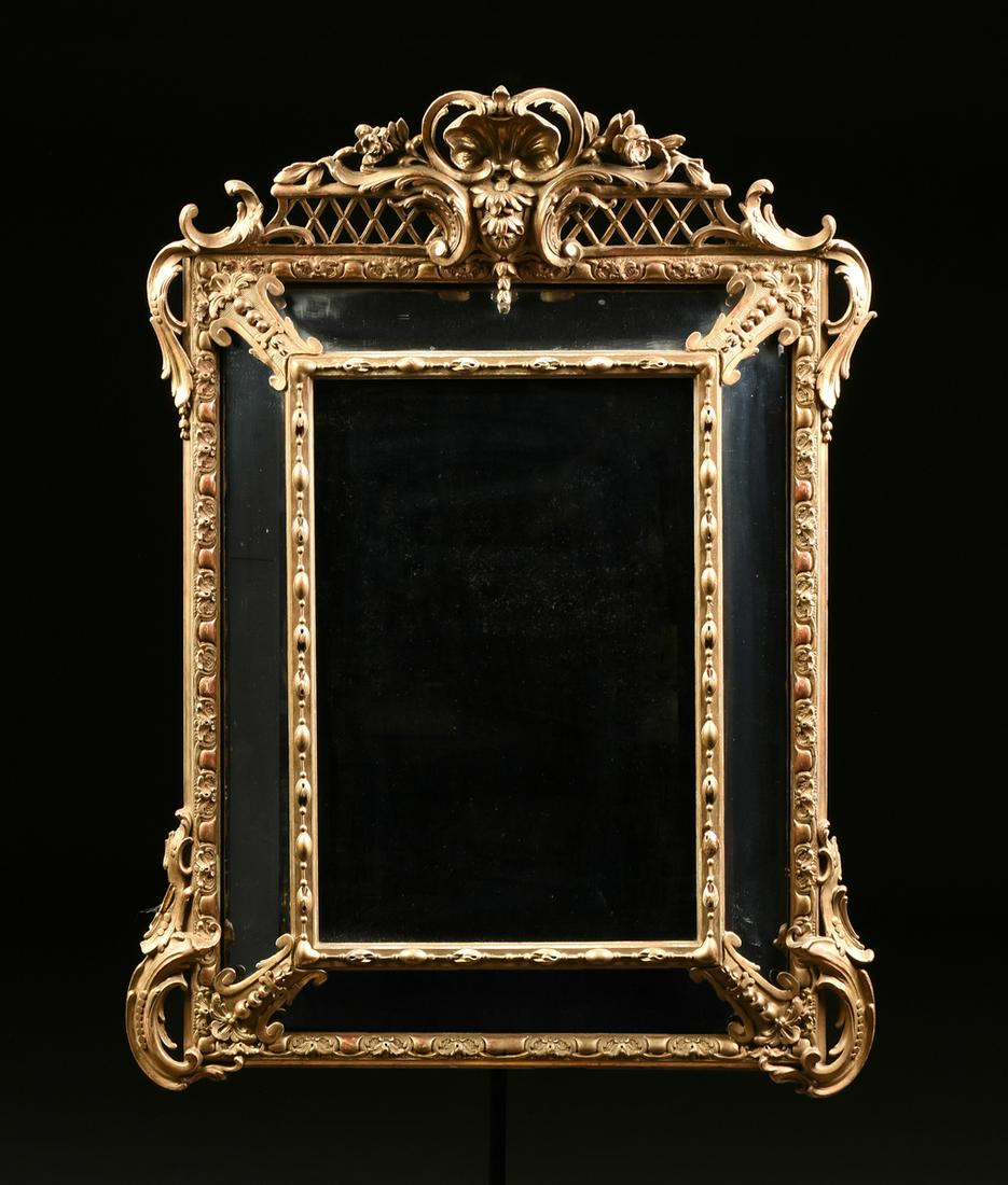 A RÉGENCE STYLE PARCEL GILT CARVED WOOD CUSHION MIRROR, (1 of 4)