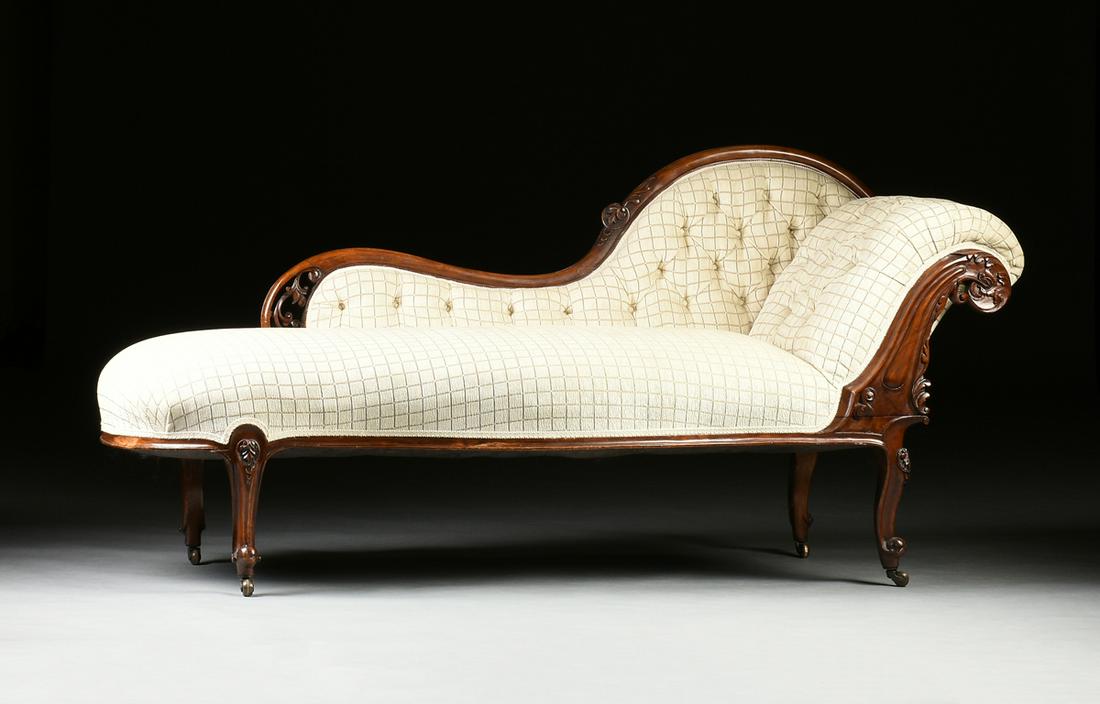 A LOUIS XV STYLE MAHOGANY CHAISE LOUNGE, MODERN,: A LOUIS XV STYLE MAHOGANY CHAISE LOUNGE, MODERN, the serpentine back and canted, scrolled arm with button tufting, fronted by a scrolling foliate carved support, over a bowed seat, raised on palmette