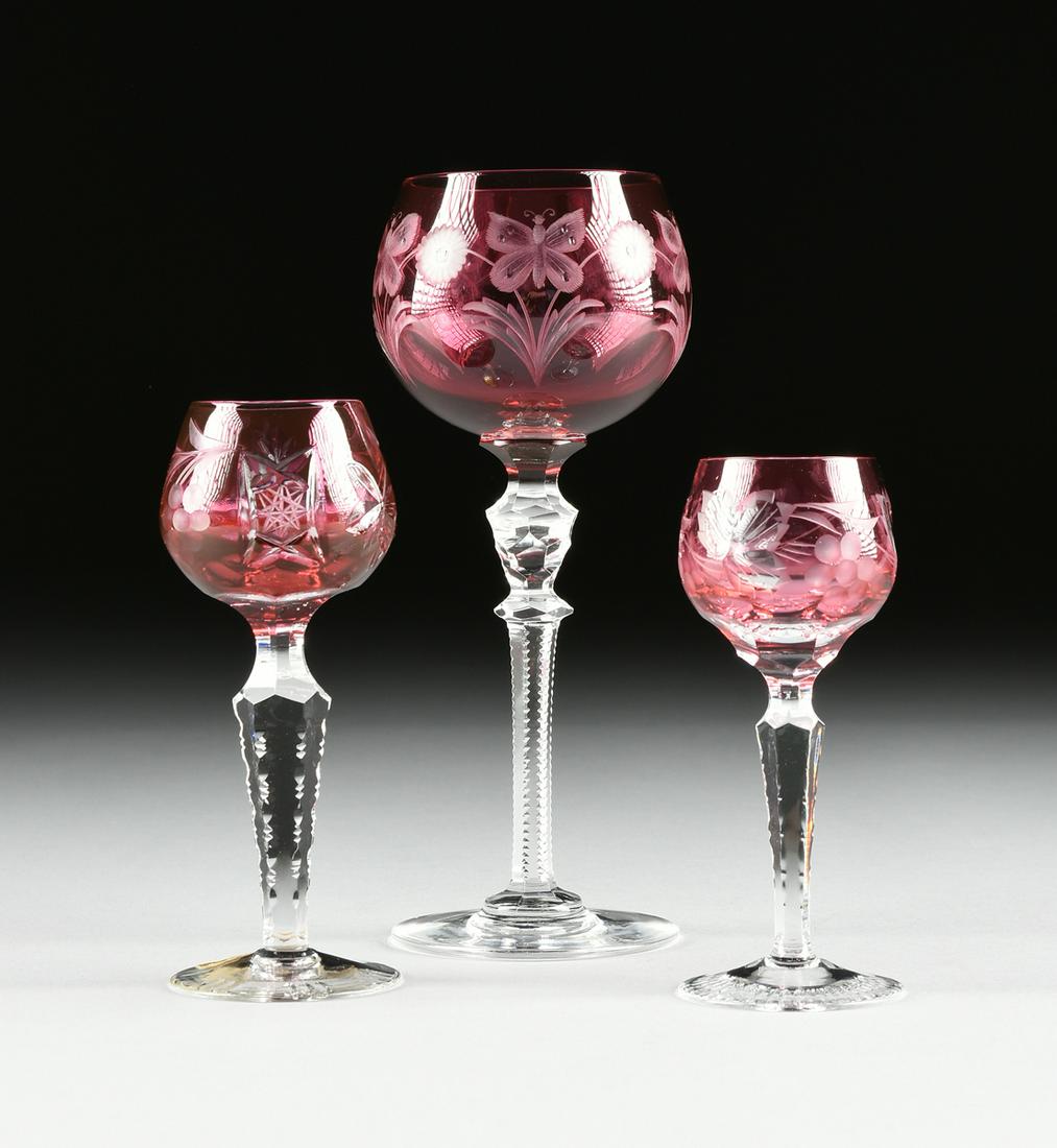 A GROUP OF THREE AMERICAN AND CONTINENTAL RUBY CUT TO: A GROUP OF THREE AMERICAN AND CONTINENTAL RUBY CUT TO CLEAR WINE STEMS, CIRCA 1900-1960, comprising an Imperlux, East German cordial glass, the teardrop form bowl cut twith grape leaf and fruit altern