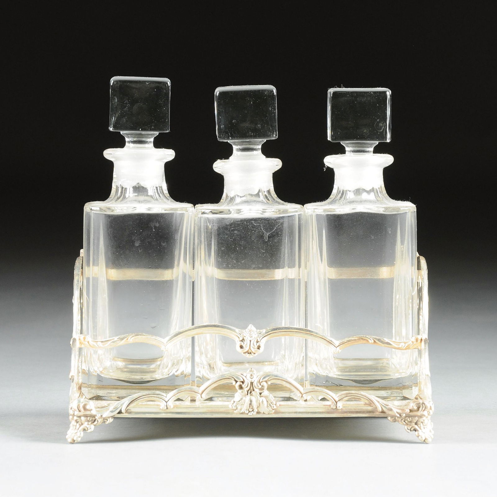 AN AMERICAN CRYSTAL AND SILVER PLATE THREE BOTTLE (1 of 4)