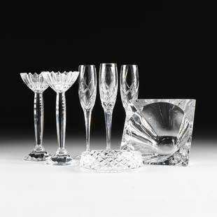 A GROUP OF EIGHT CLEAR CRYSTAL ITEMS, MODERN,: A GROUP OF EIGHT CLEAR CRYSTAL ITEMS, MODERN, comprising, four champagne flutes, an ashtray, a side bowl and and a pair of candlesticks.