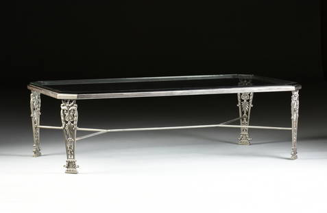 A MODERN GLASS TOP AND CAST IRON OCCASIONAL TABLE,: A MODERN GLASS TOP AND CAST IRON OCCASIONAL TABLE, the rectangular top with canted corners above tapering acanthus wrapped tapering pierced legs connected by shaped rods stretcher. Height: 18 1/8"