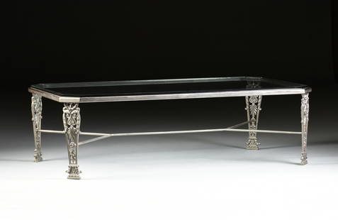 A MODERN GLASS TOP AND CAST IRON OCCASIONAL TABLE,: A MODERN GLASS TOP AND CAST IRON OCCASIONAL TABLE, the rectangular top with canted corners above tapering acanthus wrapped tapering pierced legs connected by shaped rods stretcher. Height: 18 1/8"