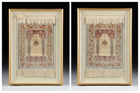 A PAIR OF DIMINUTIVE HIRAKEM SILK RUGS, EACH SIGNED AND: A PAIR OF DIMINUTIVE HIRAKEM SILK RUGS, EACH SIGNED AND FRAMED, LATE 20TH CENTURY, the central rectangular reserve woven with a deep claret ground Islamic arch enclosing the signature above scattered