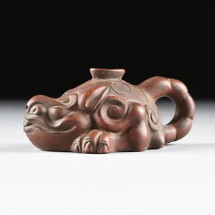 A CHINESE GLAZED STONEWARE POURING VESSEL IN THE FORM: A CHINESE GLAZED STONEWARE POURING VESSEL IN THE FORM OF A TOAD, LATE 19TH CENTURY, the bronze colored glazed pouring vessel in the form of a crouching toad, with six circular "scales" with impressed