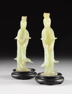 A PAIR OF CHINESE CARVED JADEITE FIGURE OF QUANYIN,: A PAIR OF CHINESE CARVED JADEITE FIGURE OF QUANYIN, 20TH CENTURY, the medium green jadeite figures of Quanyin in flowing robes, her hands calmly clasped at her waist, holding a necklace, each mounted