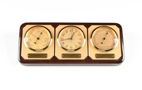 AN ASPREY LACQUERED WOOD AND BRASS DESK TOP WEATHER: AN ASPREY LACQUERED WOOD AND BRASS DESK TOP WEATHER STATION, LONDON, ENGLAND, CIRCA 1970, the lacquered wood slant front base fitted with three matte brass canted corner plaques, the one on the far