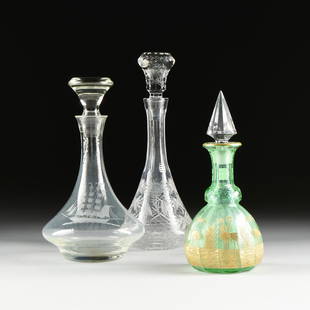 A GROUP OF THREE ANTIQUE CUT GLASS DECANTERS, 19TH/20TH: A GROUP OF THREE ANTIQUE CUT GLASS DECANTERS, 19TH/20TH CENTURY, from tallest to shortest and comprising one of trumpet form with sides centering flower buds and leafy stems decoration above a ring