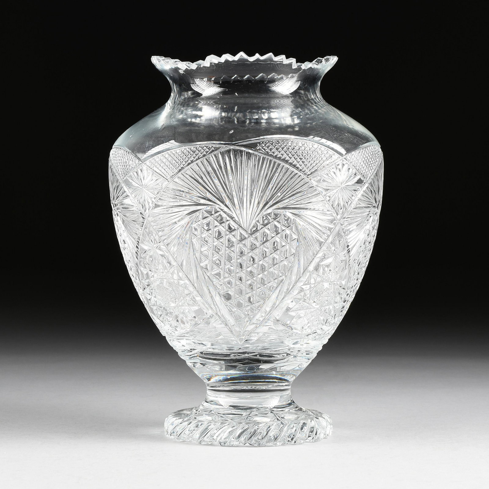 A PITKIN & BROOKS AMERICAN BRILLIANT CUT GLASS VASE IN: A PITKIN & BROOKS AMERICAN BRILLIANT CUT GLASS VASE IN THE "HEART AND HOBSTAR" PATTERN, CHICAGO, ILLINOIS, CIRCA 1907-1920, of baluster form with saw tooth rim, the body with large diamond field cente