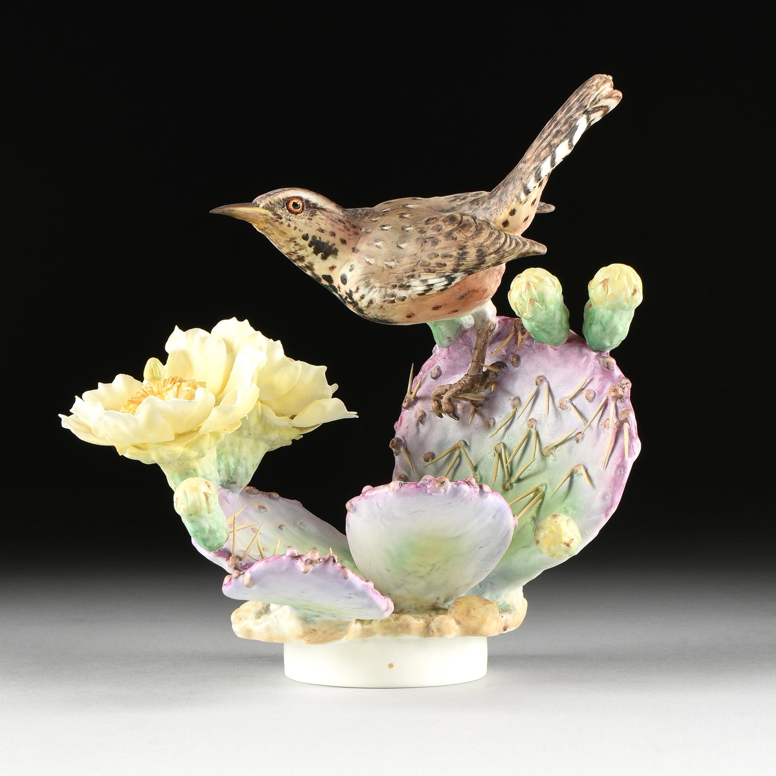 A ROYAL WORCESTER POLYCHROME BONE CHINA FIGURINE,: A ROYAL WORCESTER POLYCHROME BONE CHINA FIGURINE, "Cactus Wren & Prickly Pear Cactus," ENGLISH, CIRCA 1964, verso marked, after Dorothy Doughty (British 1892-1962). Height: 10.25" Diameter: 10"