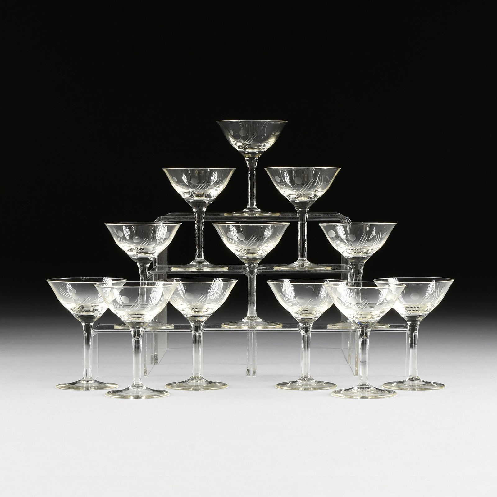 A SET OF TWELVE ART DECO CANARY YELLOW DEPRESSION GLASS: A SET OF TWELVE ART DECO CANARY YELLOW DEPRESSION GLASS ETCHED COCKTAIL GLASSES, CIRCA 1940, the everted lip bell shape bowl raised on slightly waisted stem and spreading foot, with etched dot and lin