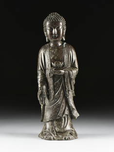 A VAJRAYANA RATNASAMBHAVA BRONZE BUDDHA SCULPTURE,: A VAJRAYANA RATNASAMBHAVA BRONZE BUDDHA SCULPTURE, CHINESE, 20TH CENTURY, the standing figure with slightly domed ushnisha and curled hair, over a happy expression with downcast eyes, above a flowing