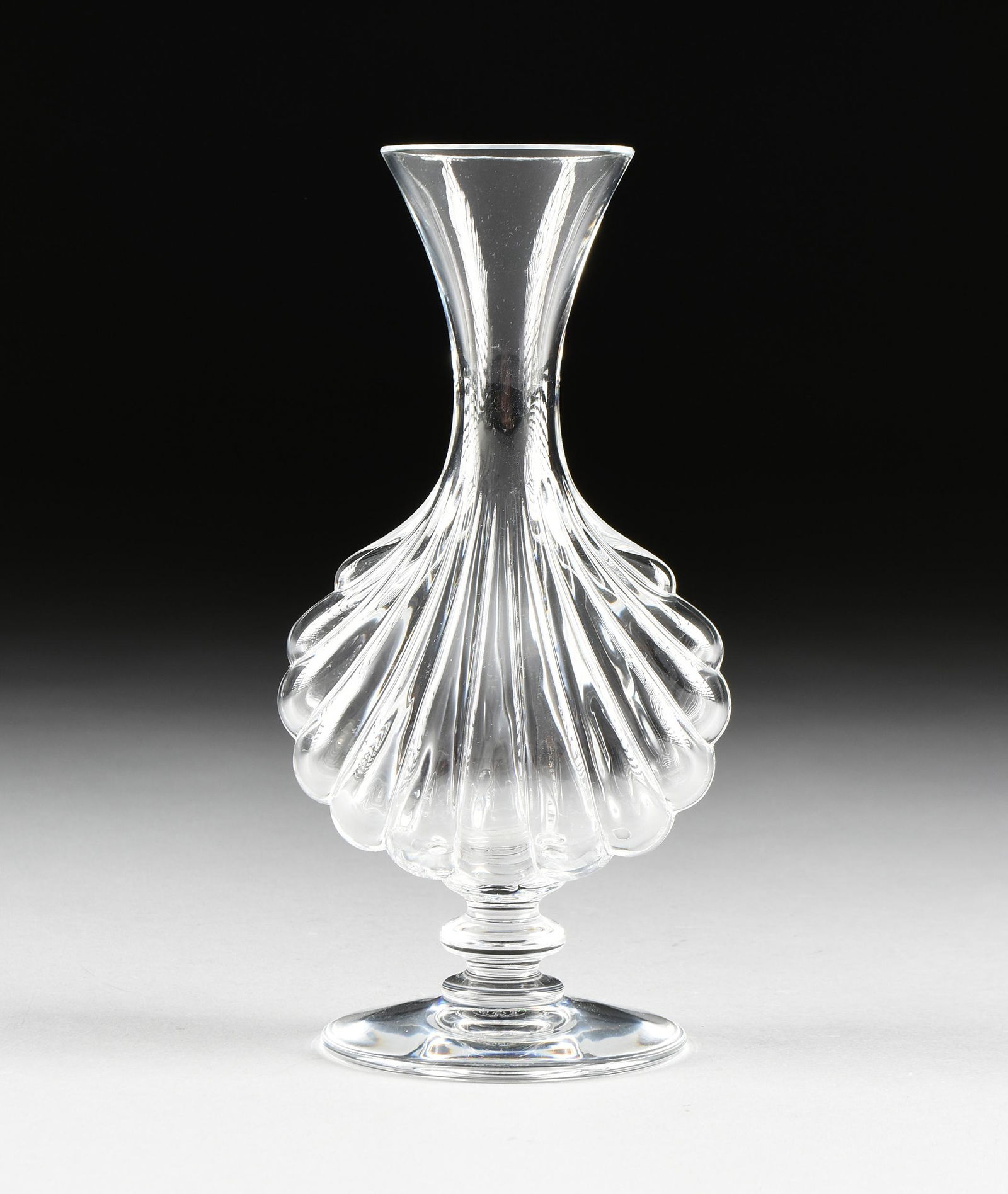 A BACCARAT MOLDED CLEAR CRYSTAL FOOTED VASE IN THE (1 of 7)