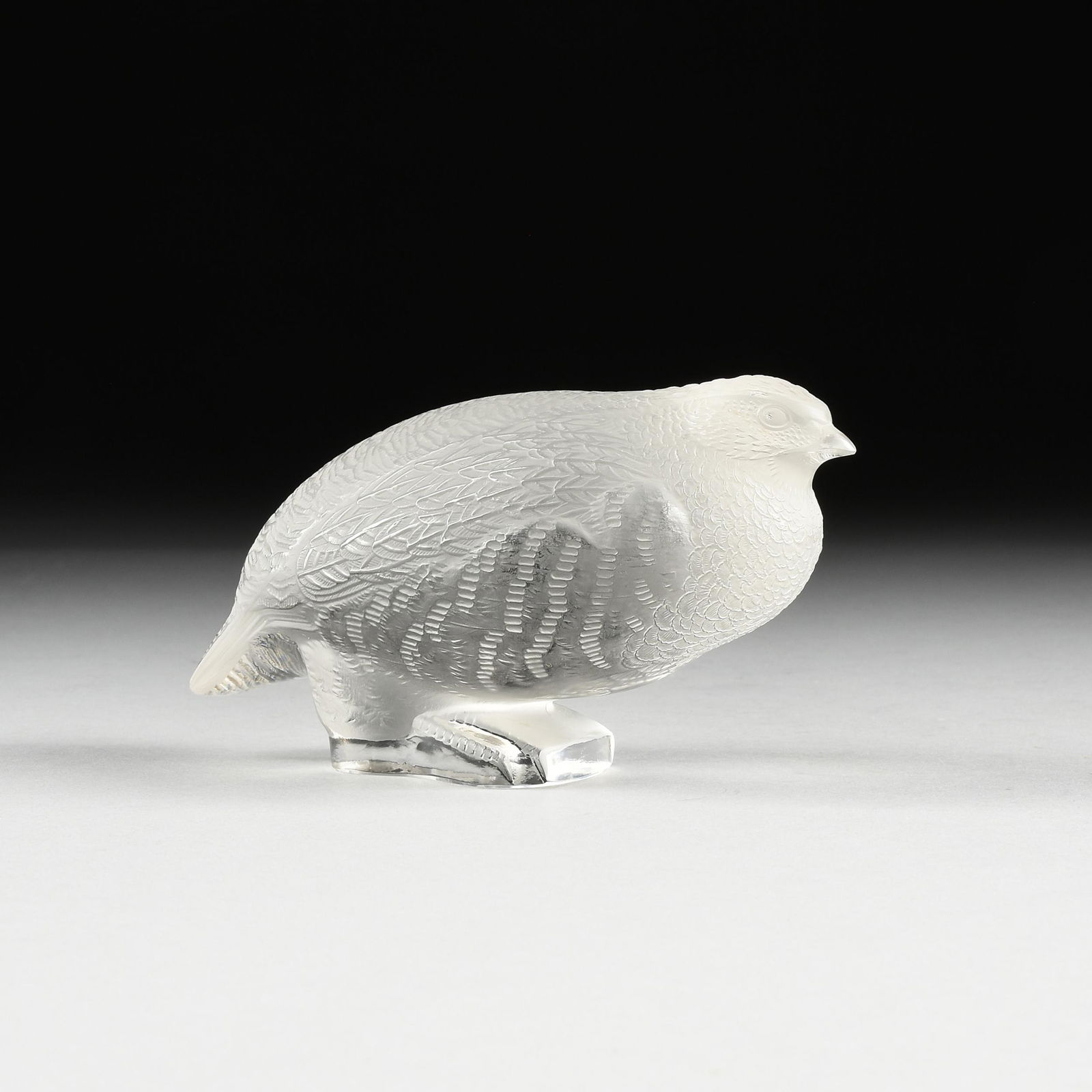 A LALIQUE FROSTED AND CLEAR CRYSTAL FIGURE OF A: A LALIQUE FROSTED AND CLEAR CRYSTAL FIGURE OF A PARTRIDGE, MODEL 11611, FRANCE, 1945-1960, the figure of a partridge standing upon a clear crystal base gazing forward, verso etched signature "LALIQUE