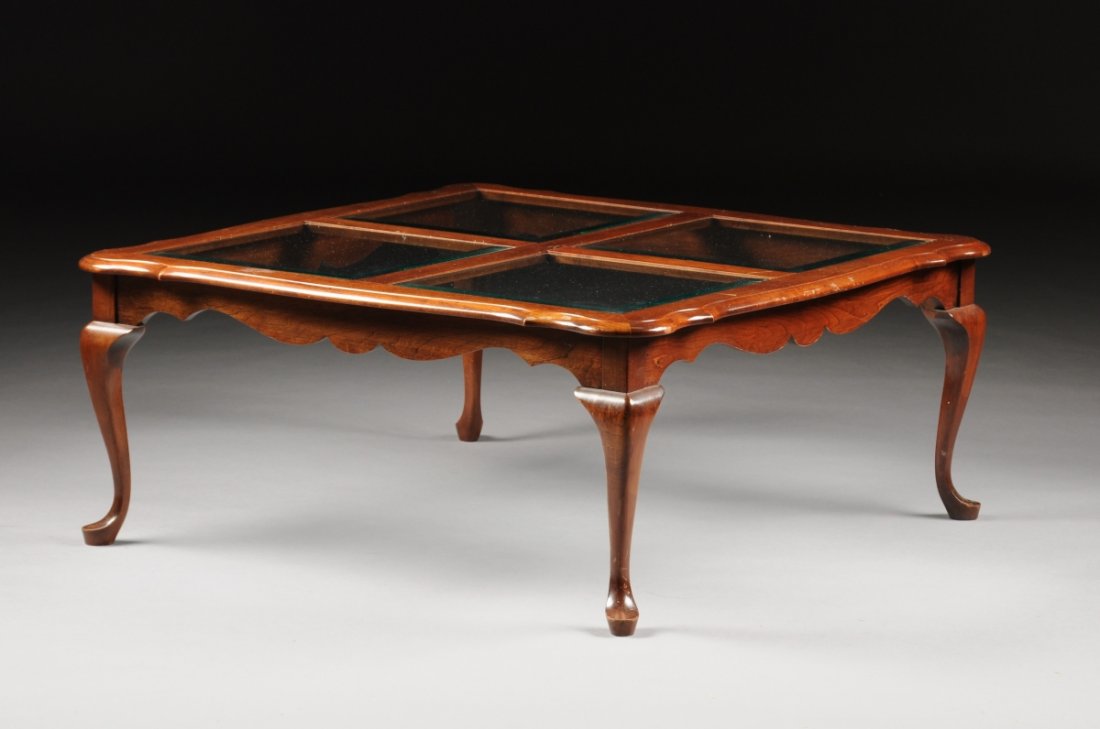 A QUEEN ANNE REVIVAL STYLE CARVED MAHOGANY AND BEVELED: A QUEEN ANNE REVIVAL STYLE CARVED MAHOGANY AND BEVELED GLASS OCCASIONAL TABLE, 20TH CENTURY, the shaped rectangular top enclosing square glass panels above a shaped frieze, raised on cabriole legs end