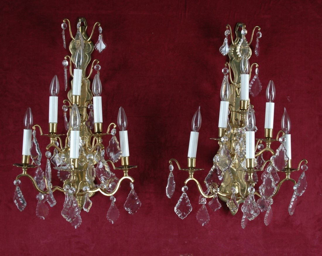 A PAIR OF LOUIS XV STYLE CUT GLASS MOUNTED GILT BRONZE: A PAIR OF LOUIS XV STYLE CUT GLASS MOUNTED GILT BRONZE SIX-LIGHT WALL APPLIQUES, 20TH CENTURY, each with shaped backplate issuing carved arms ending in flower formed bobèches and vasiform nozzles hun