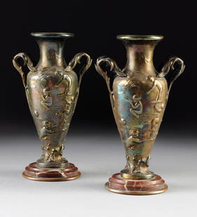 A PAIR OF ART NOUVEAU GILT SPELTER VASES, 1893-1914,: A PAIR OF ART NOUVEAU GILT SPELTER VASES, 1893-1914, each of tapering ovoid form with sides depicting frolicking putti in shallow relief beneath a flaring circular neck flanked by paired foliate