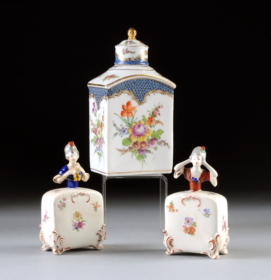 THREE HAND PAINTED PORCELAIN CANISTERS, LATE 19TH/: THREE HAND PAINTED PORCELAIN CANISTERS, LATE 19TH/ EARLY 20TH CENTURY, comprised of two figural Bavarian canisters having a rectangular shaped bottle in the form of a wide hipped ladies skirt with the