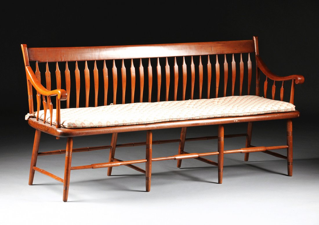 AN ANTIQUE AMERICAN CARVED CHERRYWOOD SETTEE, 19TH: AN ANTIQUE AMERICAN CARVED CHERRYWOOD SETTEE, 19TH CENTURY, the flat panel crest rail above shaped curving vertical splats flanked by rectangular and turned stiles issuing scrolled arms on similarly d