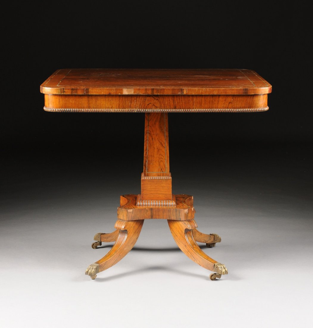 A REGENCY BRASS INLAID ROSEWOOD BREAKFAST TABLE,: A REGENCY BRASS INLAID ROSEWOOD BREAKFAST TABLE, FIRST-QUARTER 19TH CENTURY, the rectangular top with double string inlay and cross-banded border above a plain frieze with reeded edge on a rectangular