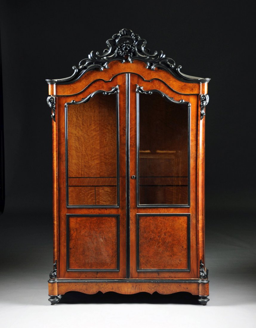A FRENCH ROCOCO REVIVAL EBONIZED WOOD, WALNUT, AND: A FRENCH ROCOCO REVIVAL EBONIZED WOOD, WALNUT, AND BIRD'S-EYE MAPLE BIBLIOTHéQUE, FOURTH-QUARTER 19TH CENTURY, the reticulated "C" scroll and blossoms carved cornice above a conforming frieze over pa