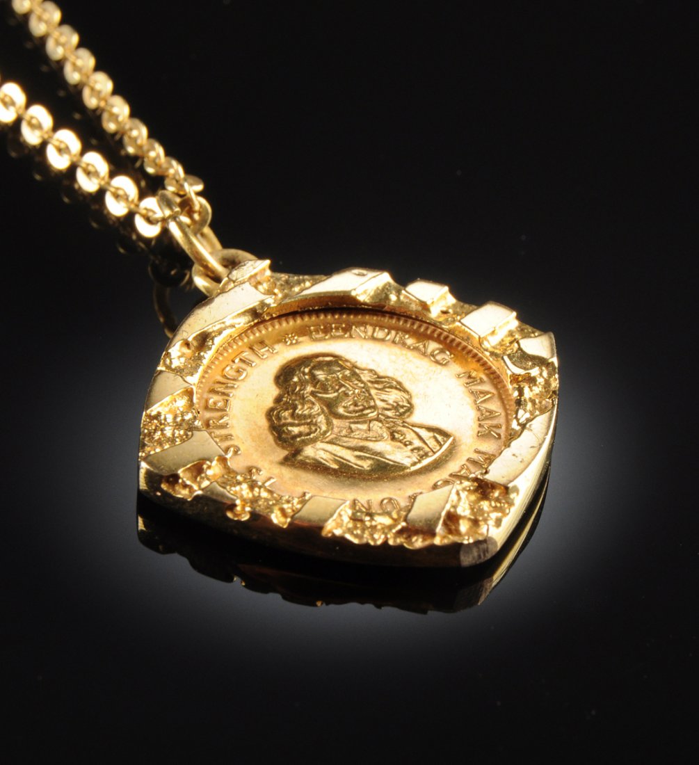 A MIXED KARAT GOLD 1 RAND LADY'S PENDANT,: A MIXED KARAT GOLD 1 RAND LADY'S PENDANT, the 18K yellow gold 18" cable chain suspending a 9K nugget pendant centering 1 Rand South African coin.