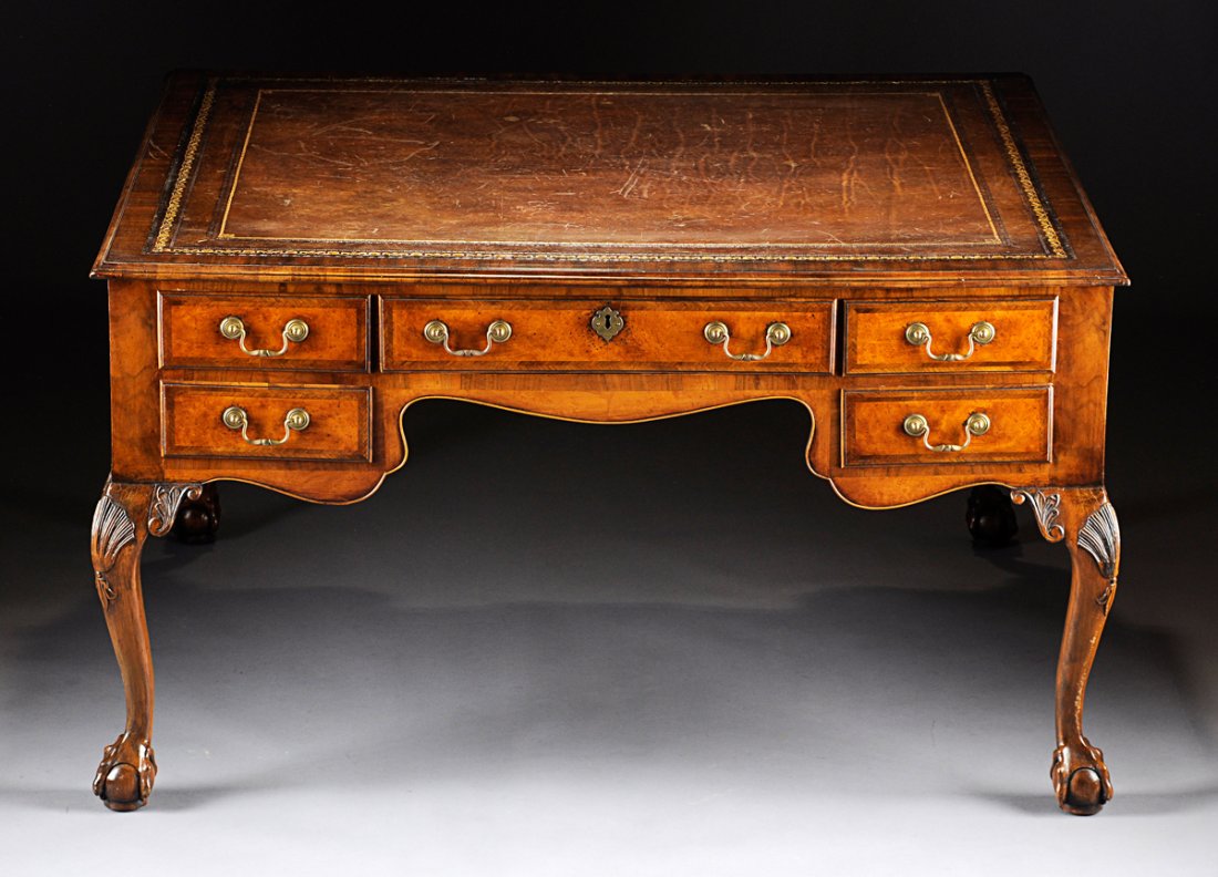 A GEORGE III STYLE WALNUT PARTNER'S DESK, THIRD QUARTER: A GEORGE III STYLE WALNUT PARTNER'S DESK, THIRD QUARTER 19TH CENTURY, the rectangular gilt tooled leather inset writing surface within kingwood cross-banding and molded trim above four short drawers w