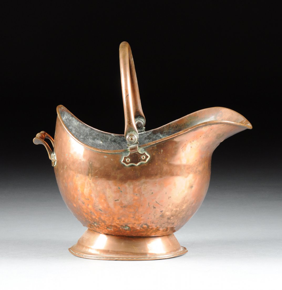 A LARGE CONTINENTAL COPPER COAL BUCKET, LATE 19TH/EARLY: A LARGE CONTINENTAL COPPER COAL BUCKET, LATE 19TH/EARLY 20TH CENTURY, the swing handle flanking the helmet shaped body with a rolled rim on an everted lip continuing to the arched back centering a rec
