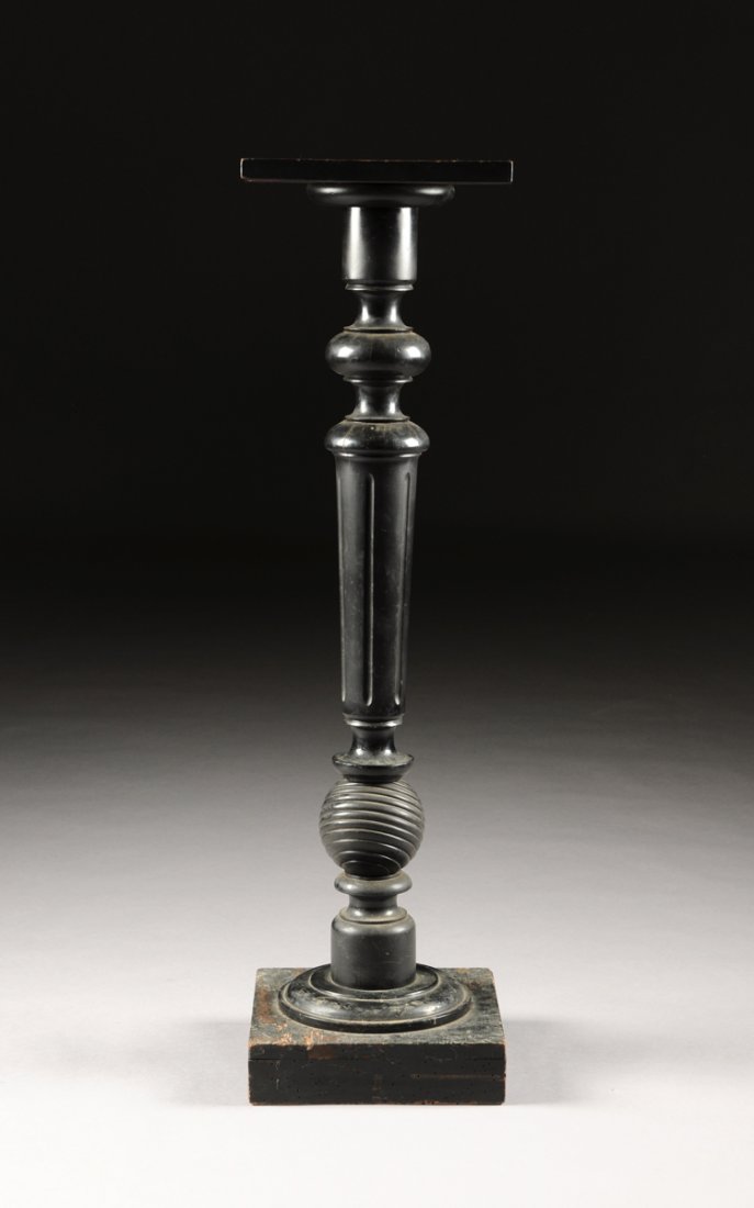 AN AESTHETIC MOVEMENT EBONIZED AND CARVED WOOD PEDESTAL: AN AESTHETIC MOVEMENT EBONIZED AND CARVED WOOD PEDESTAL, CIRCA 1875,the tapering fluted stem surmounted by a compressed bun form capital and cylindrical support, beneath a square panel top, raised on 