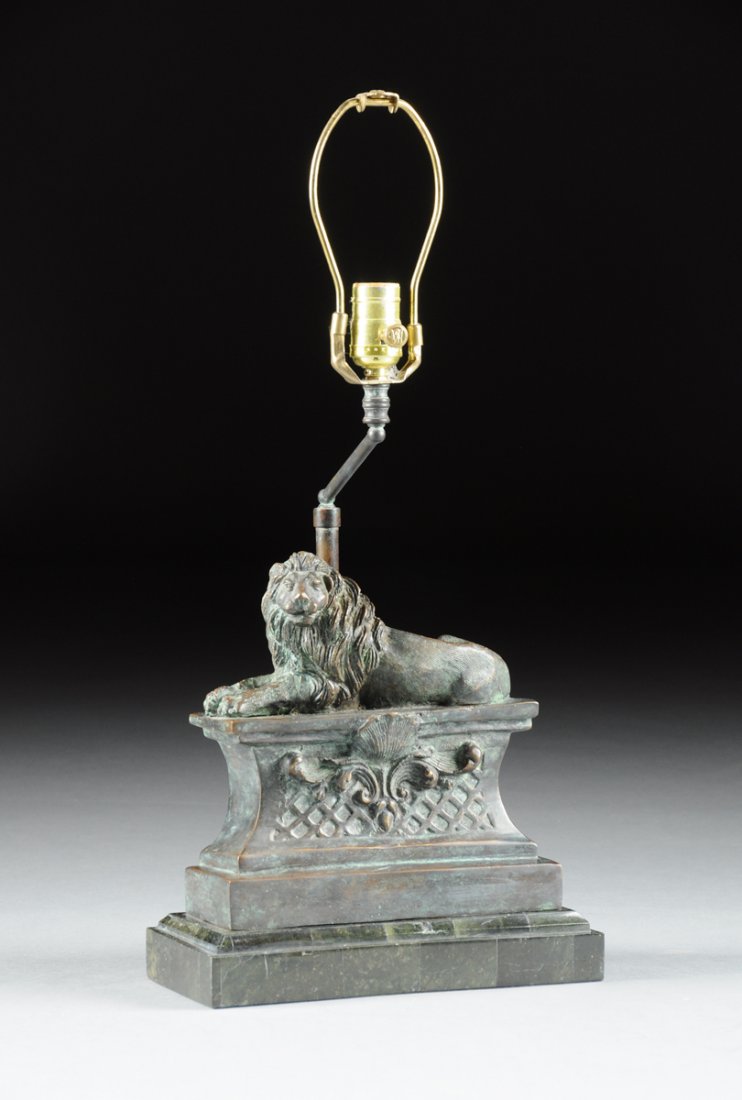 A NEOCLASSICAL STYLE PATINATED METAL RECUMBENT LION AND: A NEOCLASSICAL STYLE PATINATED METAL RECUMBENT LION AND GREEN MARBLE TABLE LAMP, MODERN, naturalistically modeled with thick mane and stern expression while resting on a rectangular wasted pedestal ce