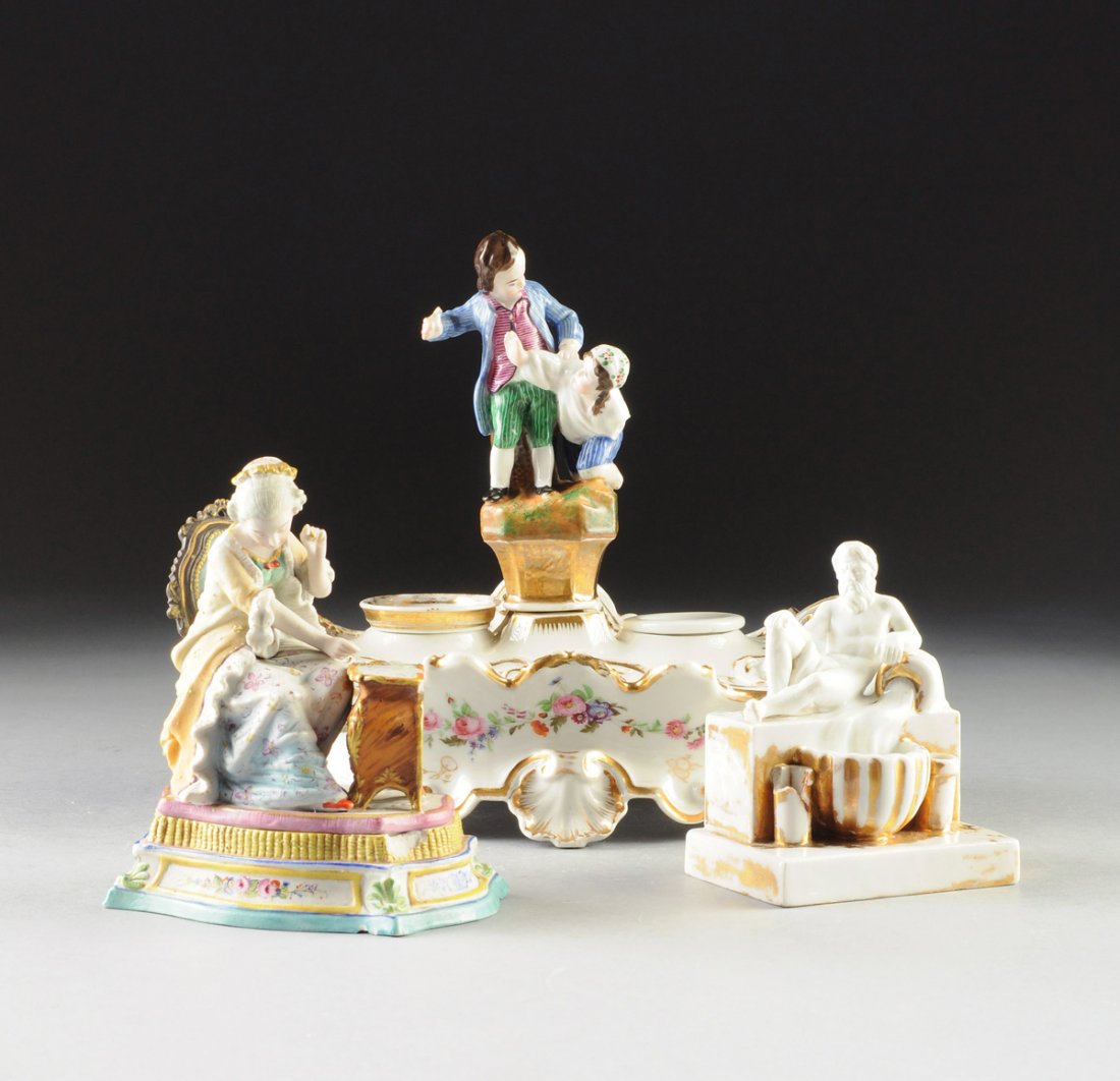 A GROUP OF THREE CONTINENTAL FIGURAL PORCELAIN: A GROUP OF THREE CONTINENTAL FIGURAL PORCELAIN INKSTANDS, MID TO LATE 19TH CENTURY, comprising one by Jacob Petit, underglaze blue "JP" initials, in the Rococo Revival taste with parcel gilt and polyc
