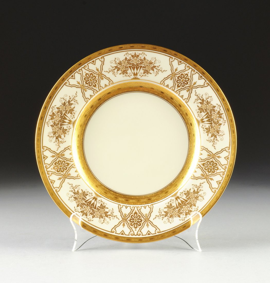 A SET OF TWELVE MINTONS PARCEL-GILT ON IVORY GROUND: A SET OF TWELVE MINTONS PARCEL-GILT ON IVORY GROUND SERVICE PLATES, PATTERN H4164, IMPRESSED AND OVERGLAZE MARKS, RETAILED BY TIFFANY & CO., ENGLISH, CIRCA 1928, each with a heavily gilt and chased ri
